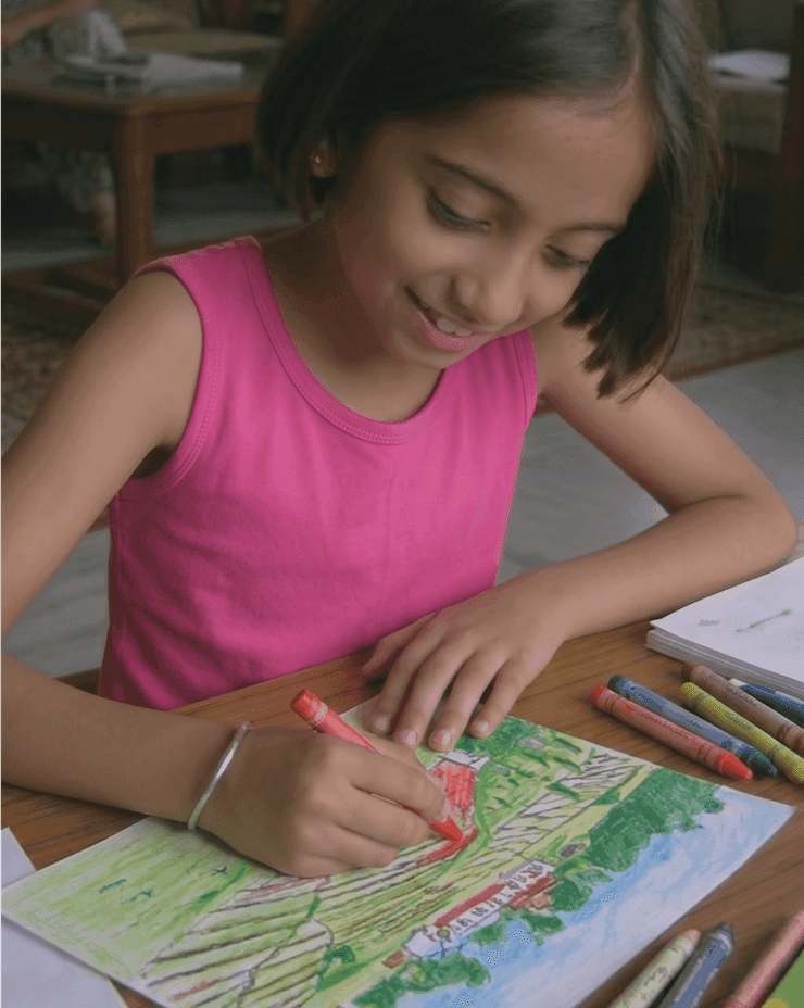 A young Aanchal holding one of her early artworks